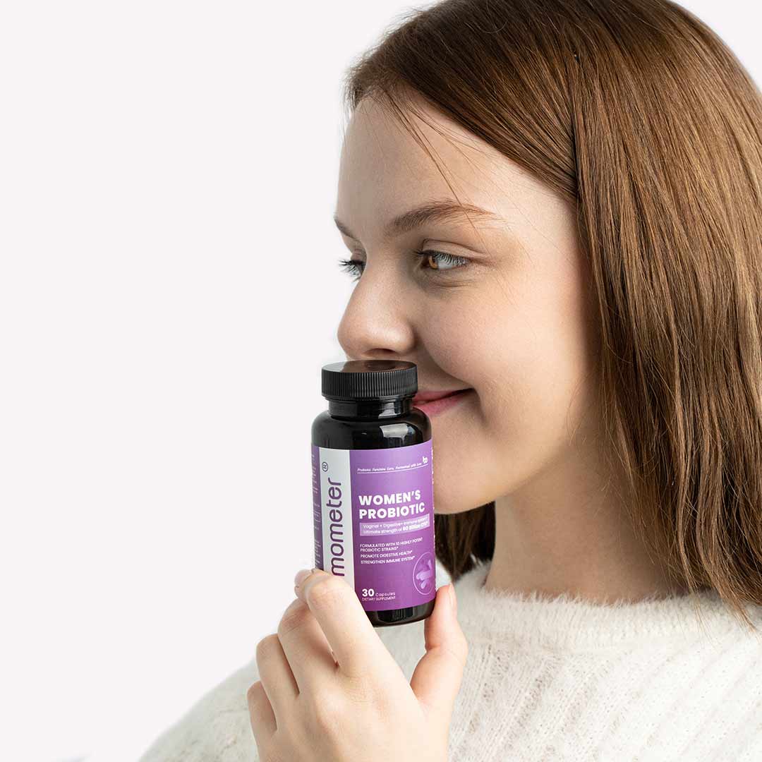 Woman holding a bottle of probiotics